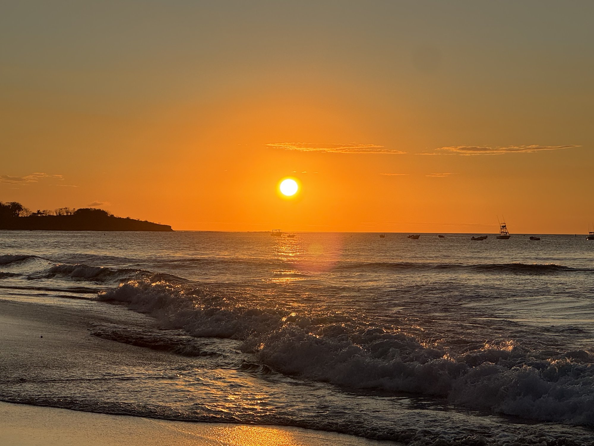 Sun setting over the waves on Tamarindo beach